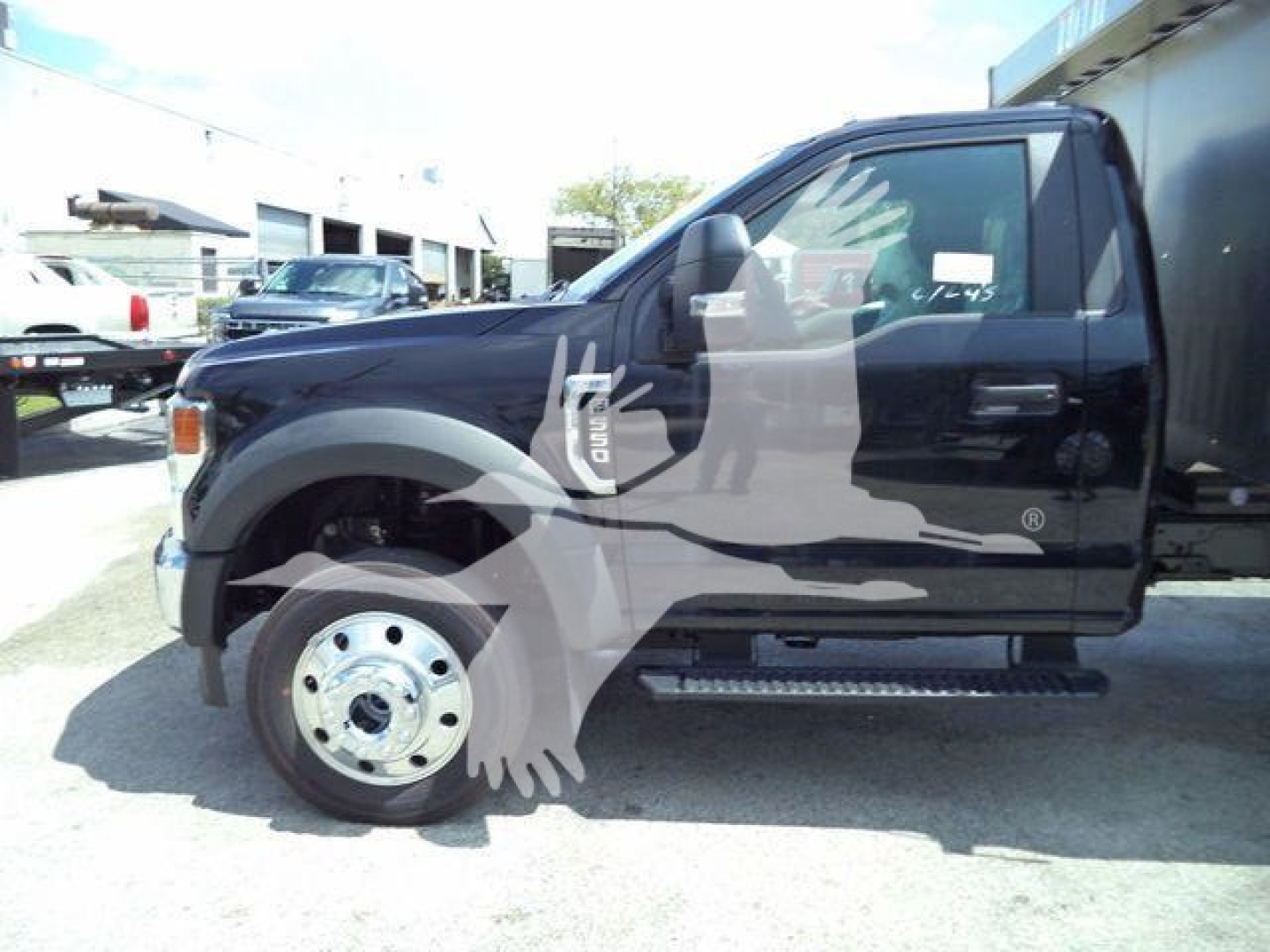 Ford F-550 truck side view showing front wheel and cab with 'F-550' emblem and running board.