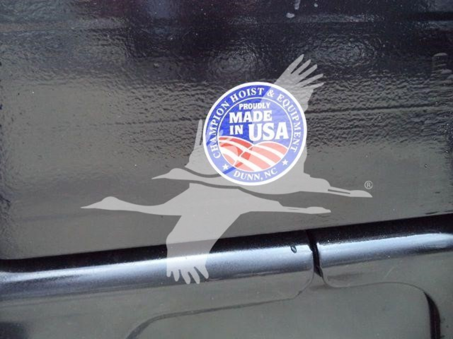 Sticker reading 'MADE IN USA' with eagle logo on a black surface, near a seam and a step/trim along the vehicle.