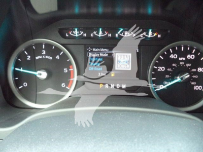 Dashboard view of a 2022 Ford F-550 instrument cluster showing speedometer, tachometer, and center display with 'Main Menu' and 'Tell Mode' text; gear selector indicator shows P R N D M.
