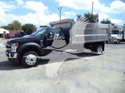 2022 Ford F-550 dump truck in a dealership lot, black cab and gray dump body visible from a front-left angle.