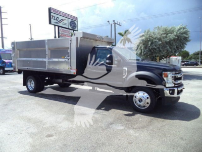Ford F-550 dump truck 4x4 in serviceable condition with aluminum dump bed and dual rear wheels.