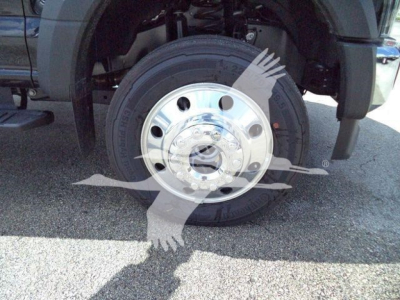 Front wheel and chrome hubcap of a Ford F-550, partial fender and tire visible.