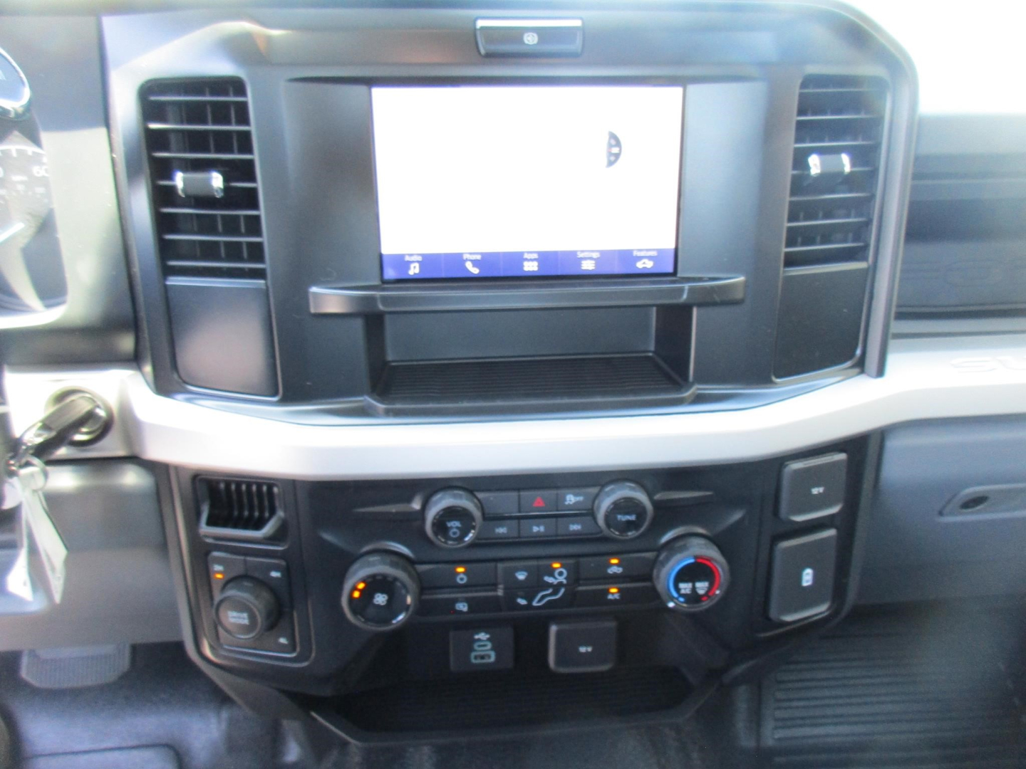 Ford F-250 dashboard center console showing touchscreen infotainment system and climate controls.