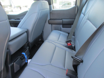 Ford F-250 Super Duty interior back seat area with gray leather-like seats and center console visible.