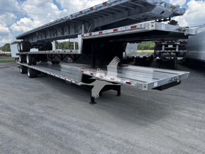 Trailer with stacked flatbed sections and a ramp, showing multiple axles and a detachable gooseneck.