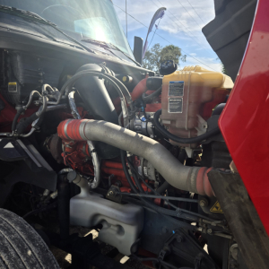 Truck engine bay showing LT625 midroof with visible coolant reservoir, hoses, and turbocharger.