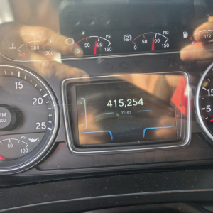 Instrument cluster and digital odometer showing 415,254 miles in a sleeper trucks dashboard.