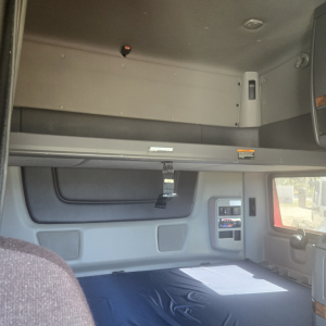 Interior sleeper cab area of a 2020 International LT625 mid-roof truck showing upper bunk area and window controls.