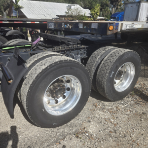 Truck rear axles and wheels of a 2020 International LT625MIDROOF chassis showing dual rear tires and frame rails.