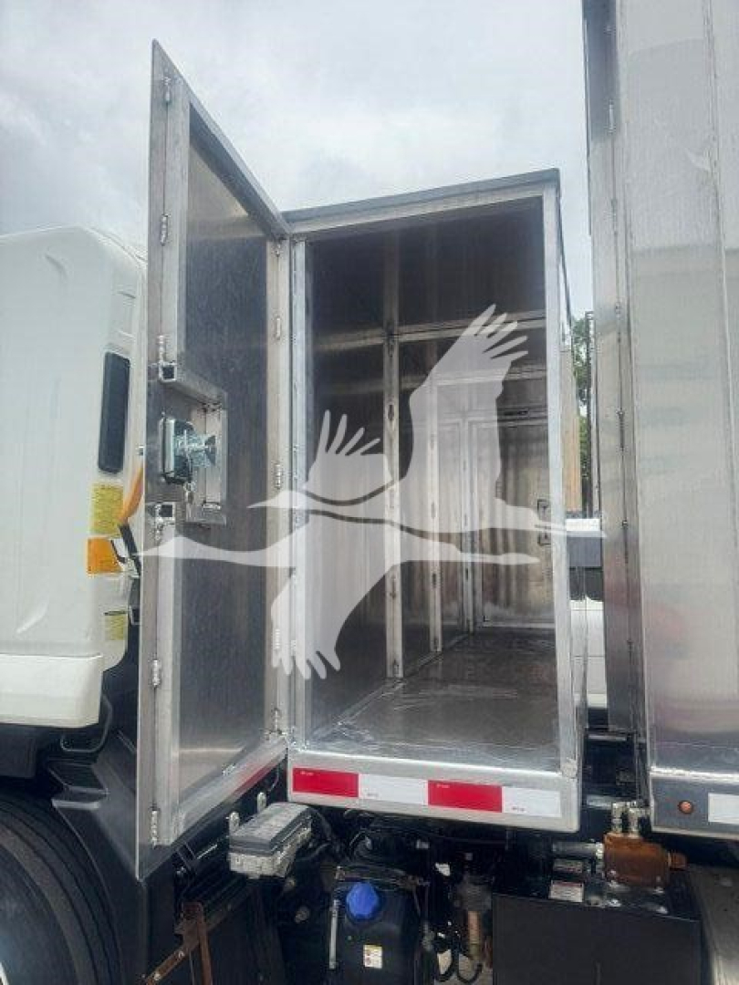 Isuzu NPR or similar truck cargo area with rear doors open showing empty interior cargo space and partitions.