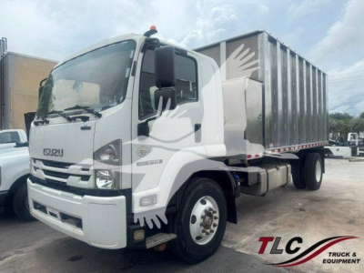 Isuzu truck in cab forward view with dump bed, front grille with Isuzu badge, white color, side mirrors, headlights, and trailer at rear