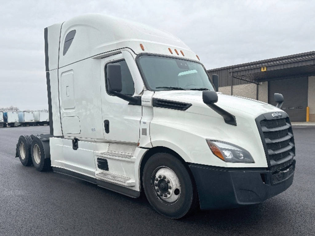 2021 Freightliner Cascadia126 tractor in a light color with sleeper cab, showing front and side, no visible labels or stickers readable.