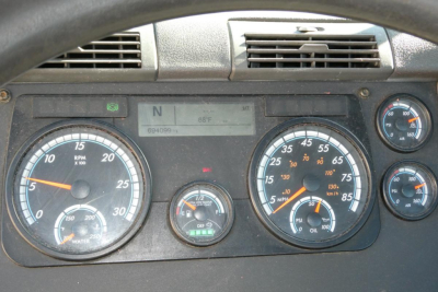 Truck dashboard cluster with multiple gauges and digital display showing N and 68°F, left tachometer, right speedometer and auxiliary gauges.