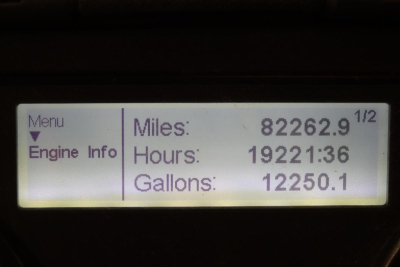 Vehicle instrument display showing Miles: 82262.9, Hours: 19221:36, Gallons: 12250.1 with Menu and Engine Info labels.