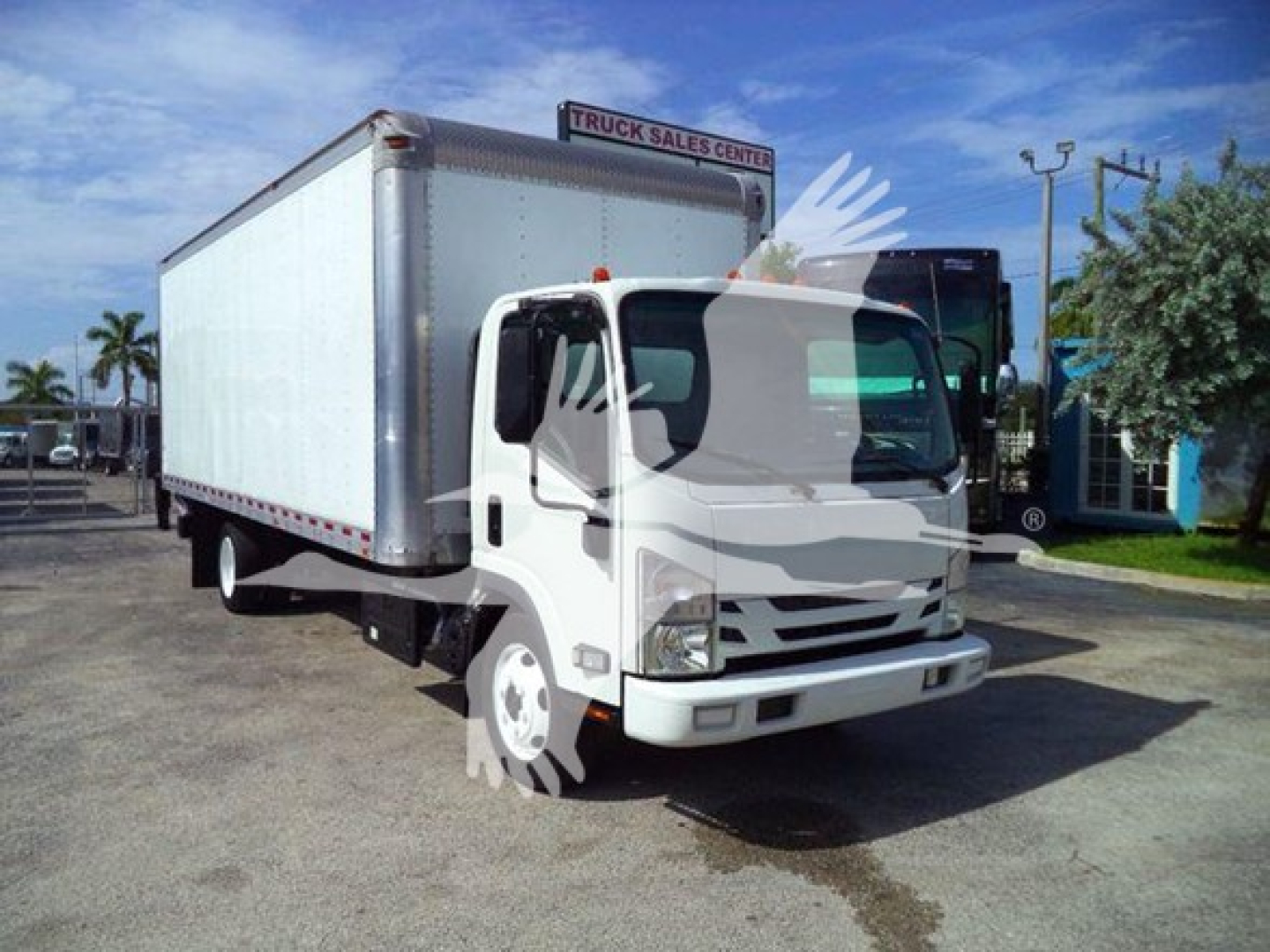 Isuzu NRR box truck showing cargo box and cab in a dealership lot.