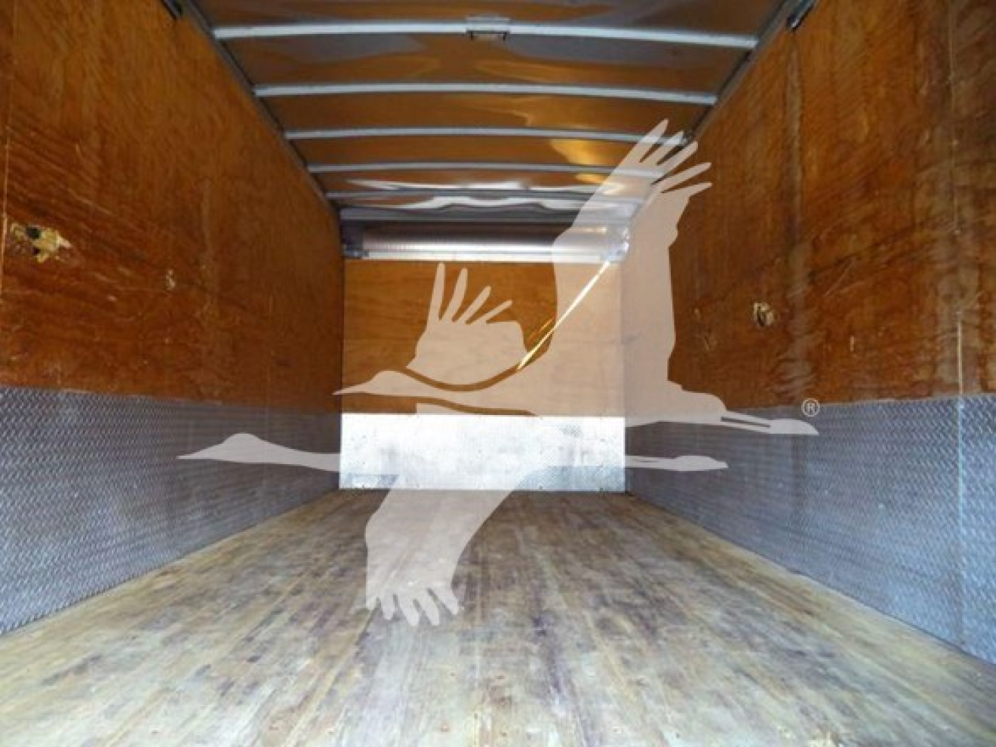 Isuzu NRR truck cargo area showing wooden walls and metal floor inside a box body.