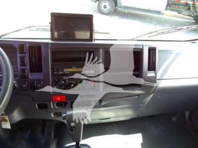 Isuzu NRR truck interior dashboard with GPS screen and central control panel visible.