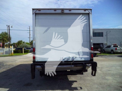 Rear view of a box truck with a white bird graphic on the back doors. No legible text visible on the truck doors.