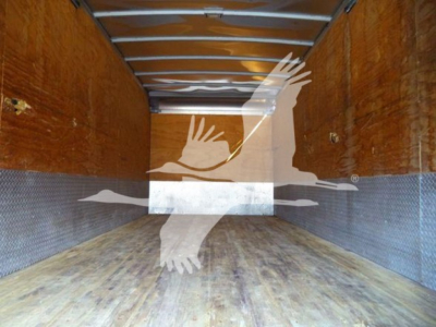 Isuzu NRR truck cargo area showing wooden walls and metal floor inside a box body.