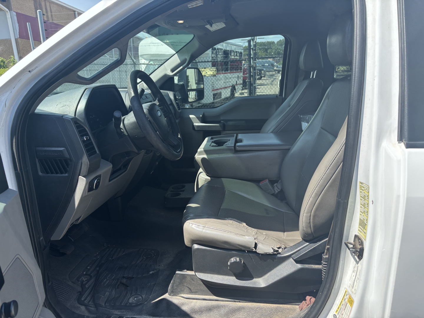 Ford F-250 cab and chassis interior showing front seats, steering wheel, and dashboard view.