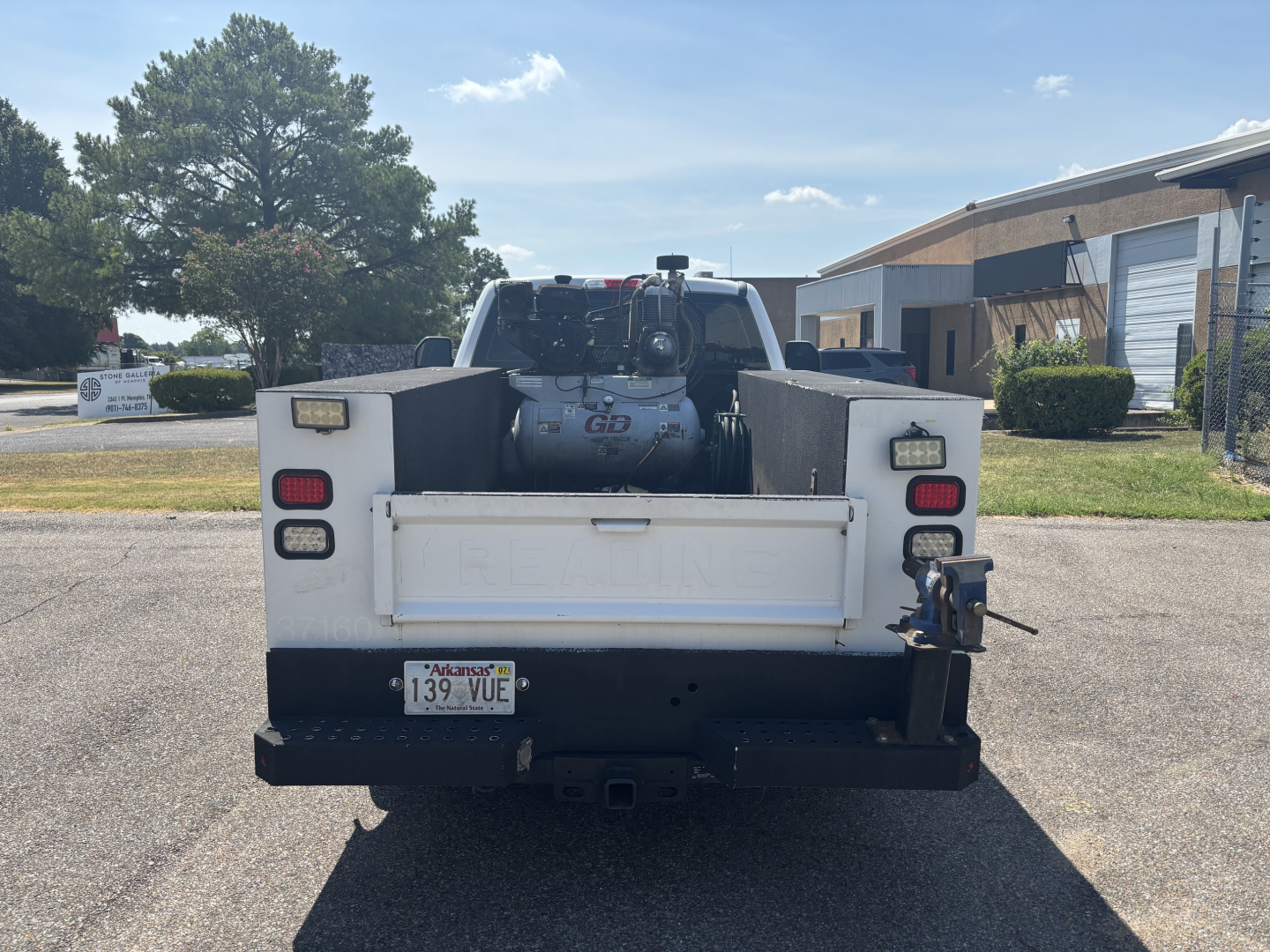 Truck bed rear view showing winch and rear bumper with license plate Arkansas 139 VUE and tow hitch.