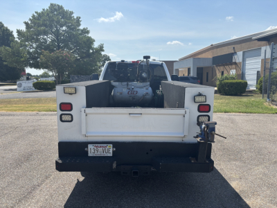 Truck bed rear view showing winch and rear bumper with license plate Arkansas 139 VUE and tow hitch.