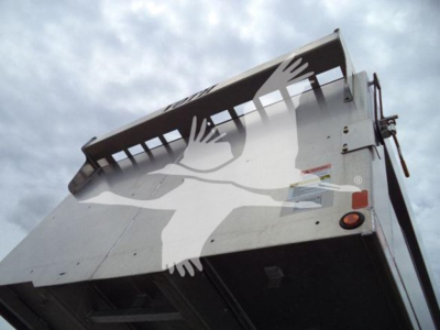 Isuzu NPR HD truck bed side view showing metal panels and tailgate mechanism.