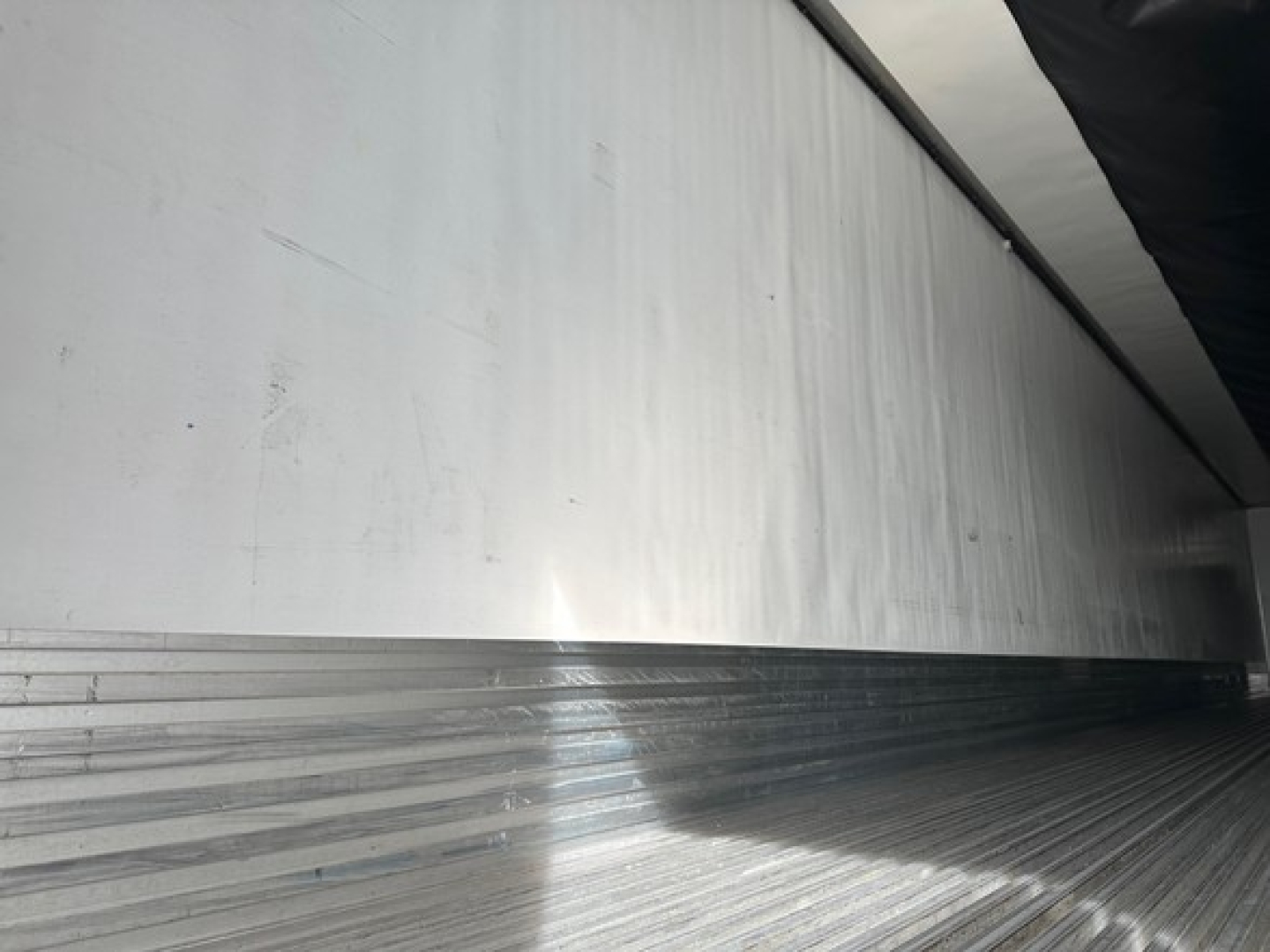 Image of a Utility reefer trailer interior with aluminum side wall and ribbed floor.