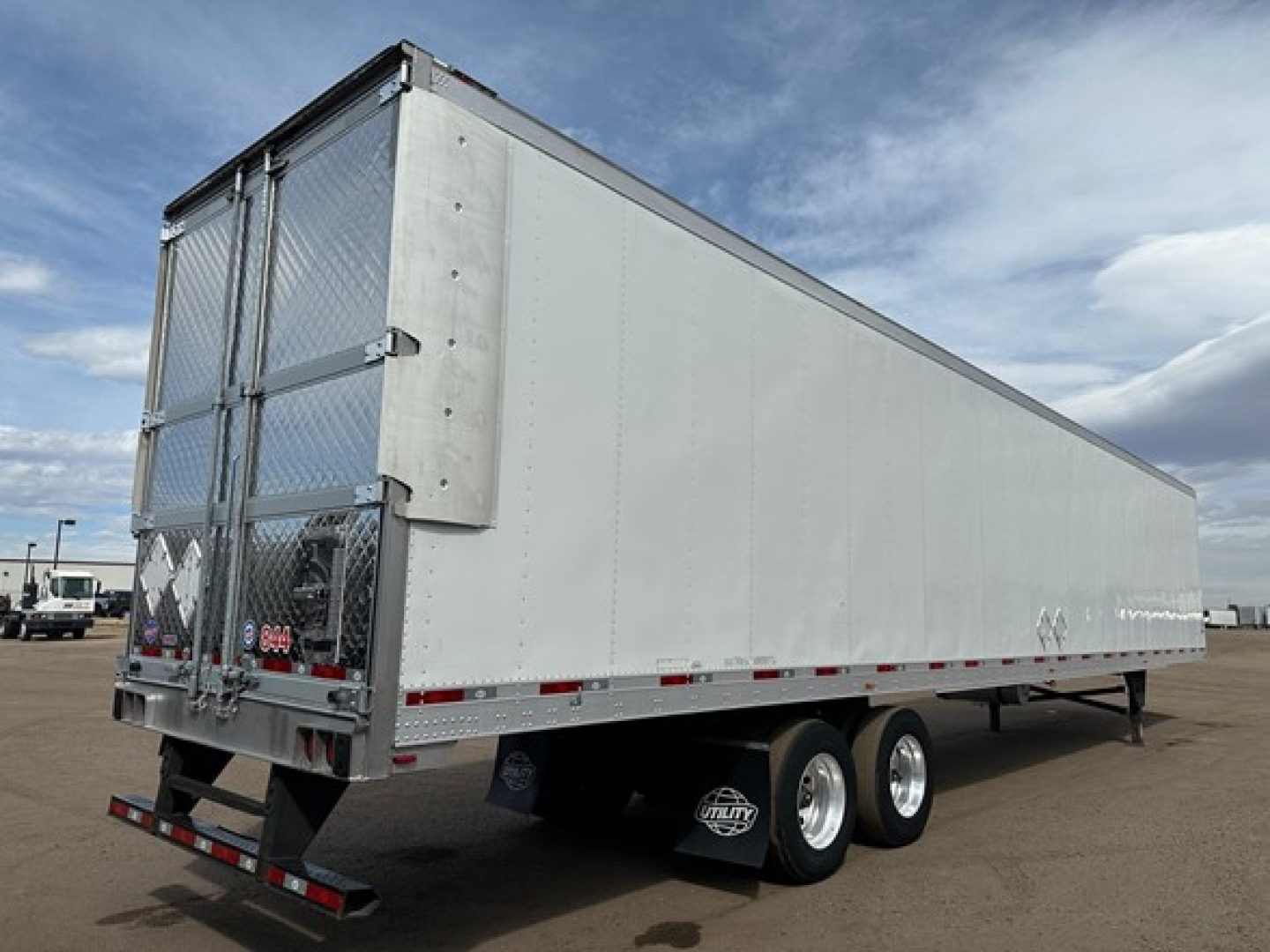 Utility 3000R trailer side view showing aluminum reefer trailer with dual rear doors and tandem axles.
