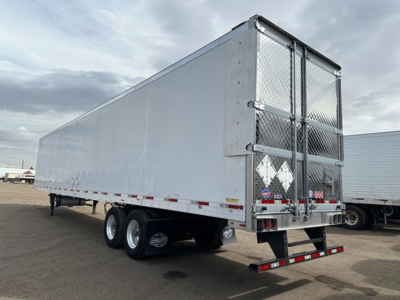 Trailer rear and side view of a 2022 Utility 3000R reefer trailer showing dual rear doors with diamond plate and warning decals.