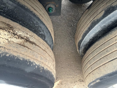 Trailer axle tires and dirt on dual rear tires of a 2022 Utility 3000R reefer trailer showing worn tread and dust buildup.