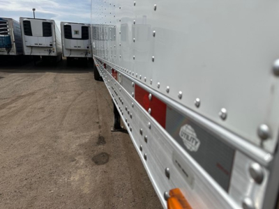 Trailer side panel of a 2022 Utility 3000R reefer trailer showing riveted aluminum side with reflective strip and Utility logo plate.
