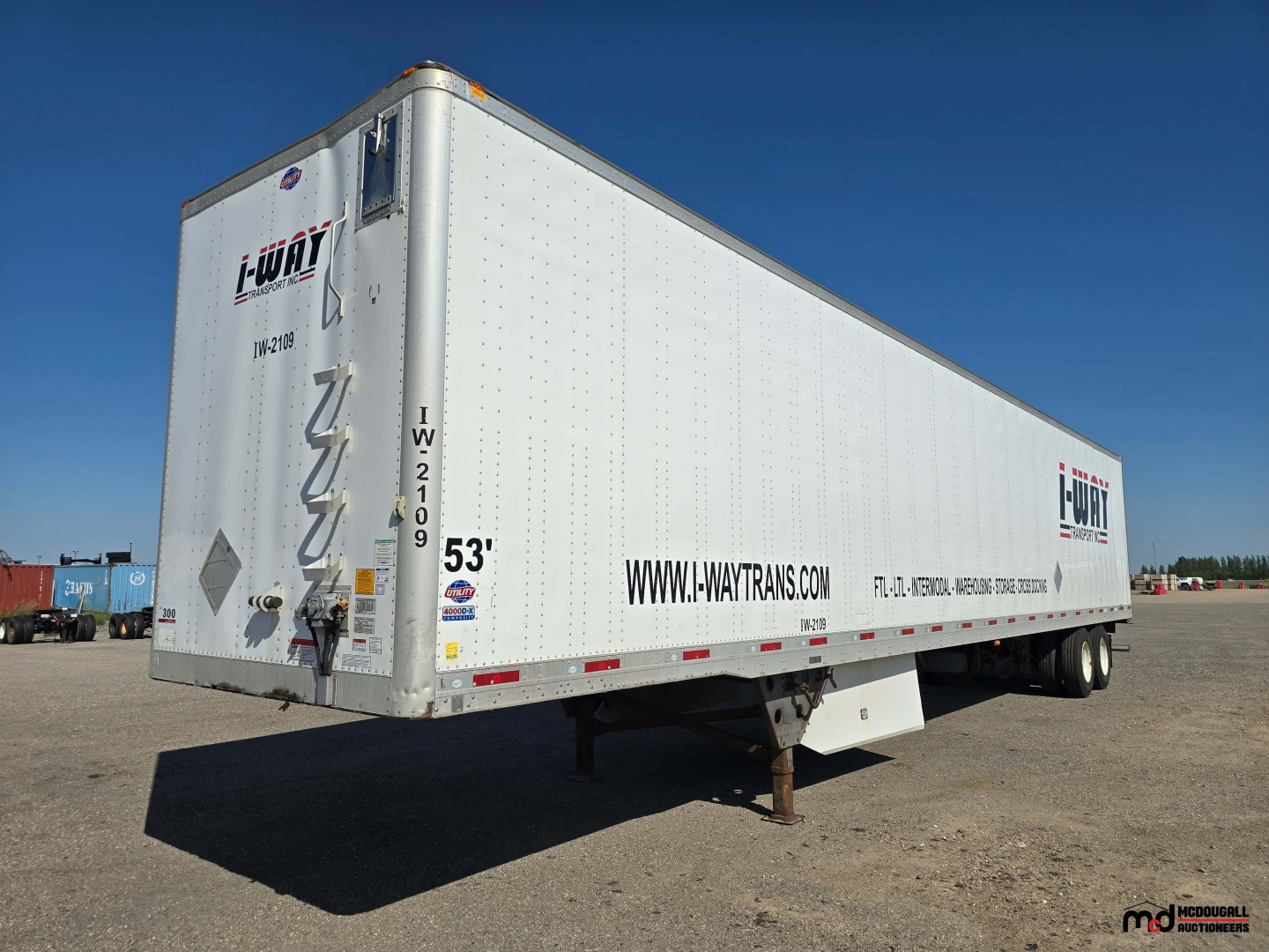 53' dry van trailer showing i-UT brand logos and www.i-waitrans.com on side, tandem axles, rear doors, undercarriage with support legs.