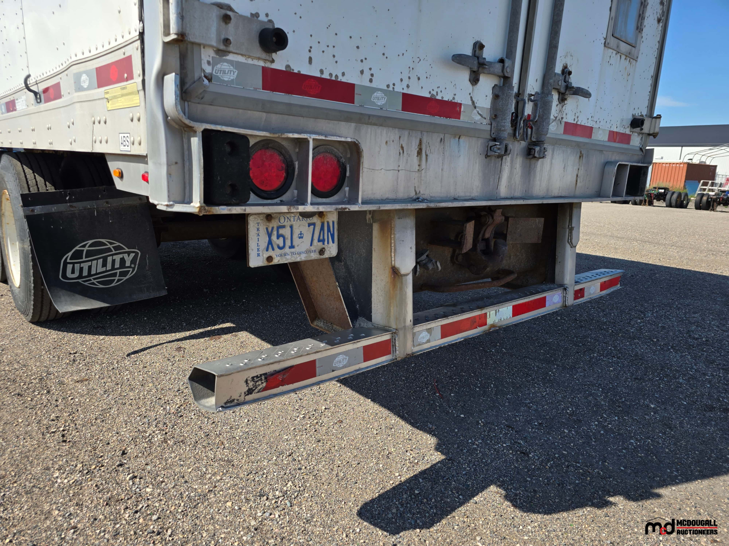 Rear view of a 2020 Utility 4000D-X 53' tandem dry van trailer showing bumper with reflective tape, rear doors, and license plate with dirt marks.