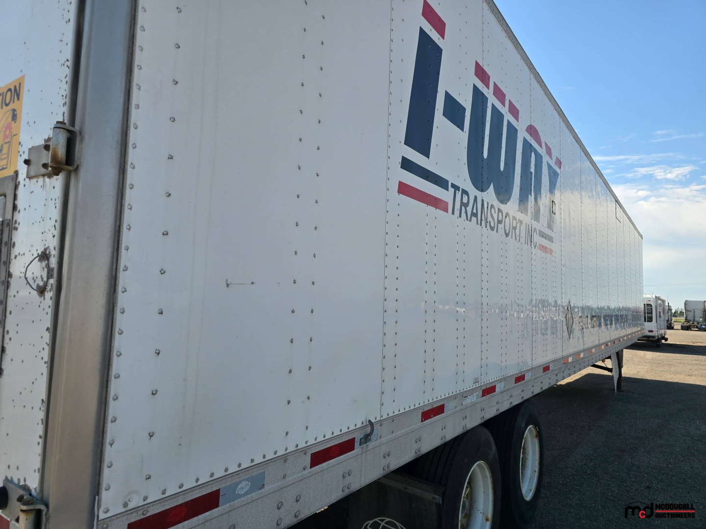 Utility 4000D-X 53' tandem dry van trailer side view showing I-UT logo with riveted white aluminum exterior and dual rear wheels.