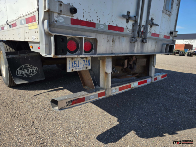 Rear view of a 2020 Utility 4000D-X 53' tandem dry van trailer showing bumper with reflective tape, rear doors, and license plate with dirt marks.