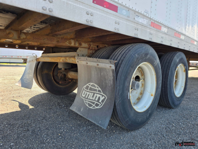 Trailer rear wheels and suspension of a 2020 Utility 4000D-X 53' tandem dry van trailer showing dual axles, mudflaps with Utility logo, and undercarriage details.