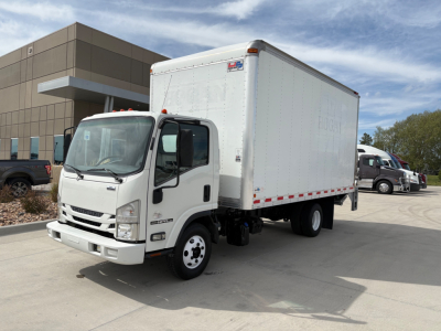 Isuzu NPR-HD box truck with white cab and cargo box, side-view showing cab interior and front grille.