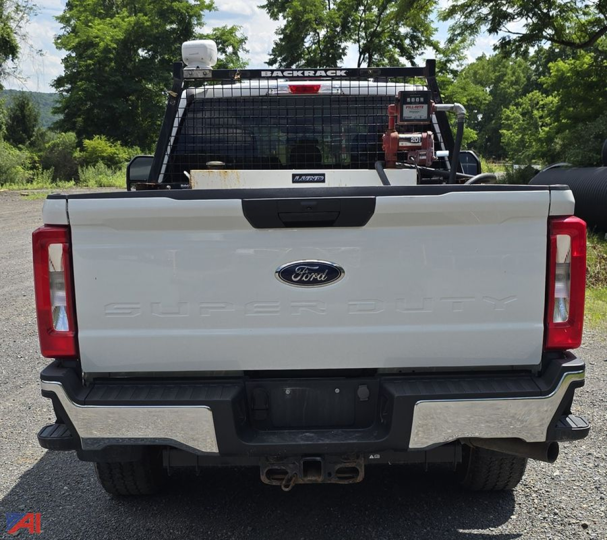 Ford F-350 Super Duty rear view showing tailgate with Ford logo and SAOB Dodge? Wait no. The image shows a white Ford F-350 Super Duty with a plow setup and rear bumper. Tailgate reads SUPER DUTY and Ford emblem.