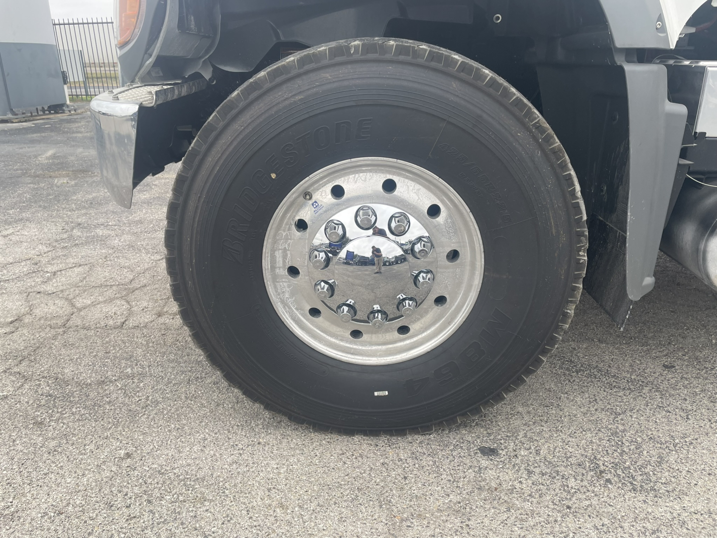 Mack GR84FT front wheel showing polished chrome hub, lug nuts, and black tire in close-up