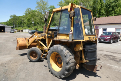 Case 480C backhoe loader in-service showing side view with front loader bucket and rear stabilizers.