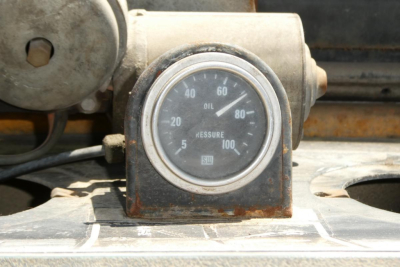 Case 480C loader dashboard gauge showing oil pressure and other indicators.