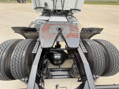 Rear view of a 2022 Mack AN42T truck chassis showing dual rear axles, fifth wheel, and suspension details.
