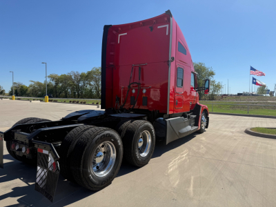 Kenworth T680 2023 rear and side view showing sleeper cab and dual rear axles with red paint.