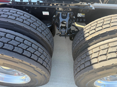Kenworth truck chassis with dual rear axles and tires visible, showing the fifth wheel area and frame cross members.