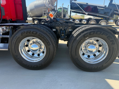 Dual rear wheel setup of a 2023 Kenworth T680 truck showing ProSeries tire brands and chrome hubcaps.