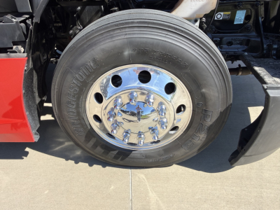 Kenworth T680 wheel with Bridgestone tire and chrome hubcap visible in front fender area.