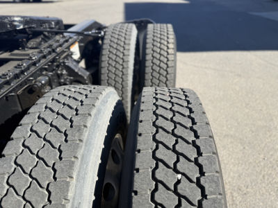 Tractor-trailer rear wheels and dual tires from a Mack ANTHEM truck showing tread pattern and sidewall details.