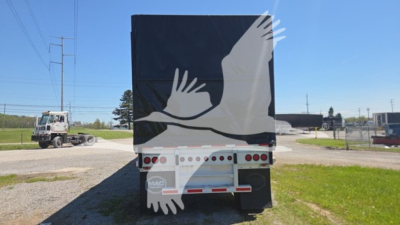 Trailer rear view showing curtain side trailer with MAC branding and back doors.