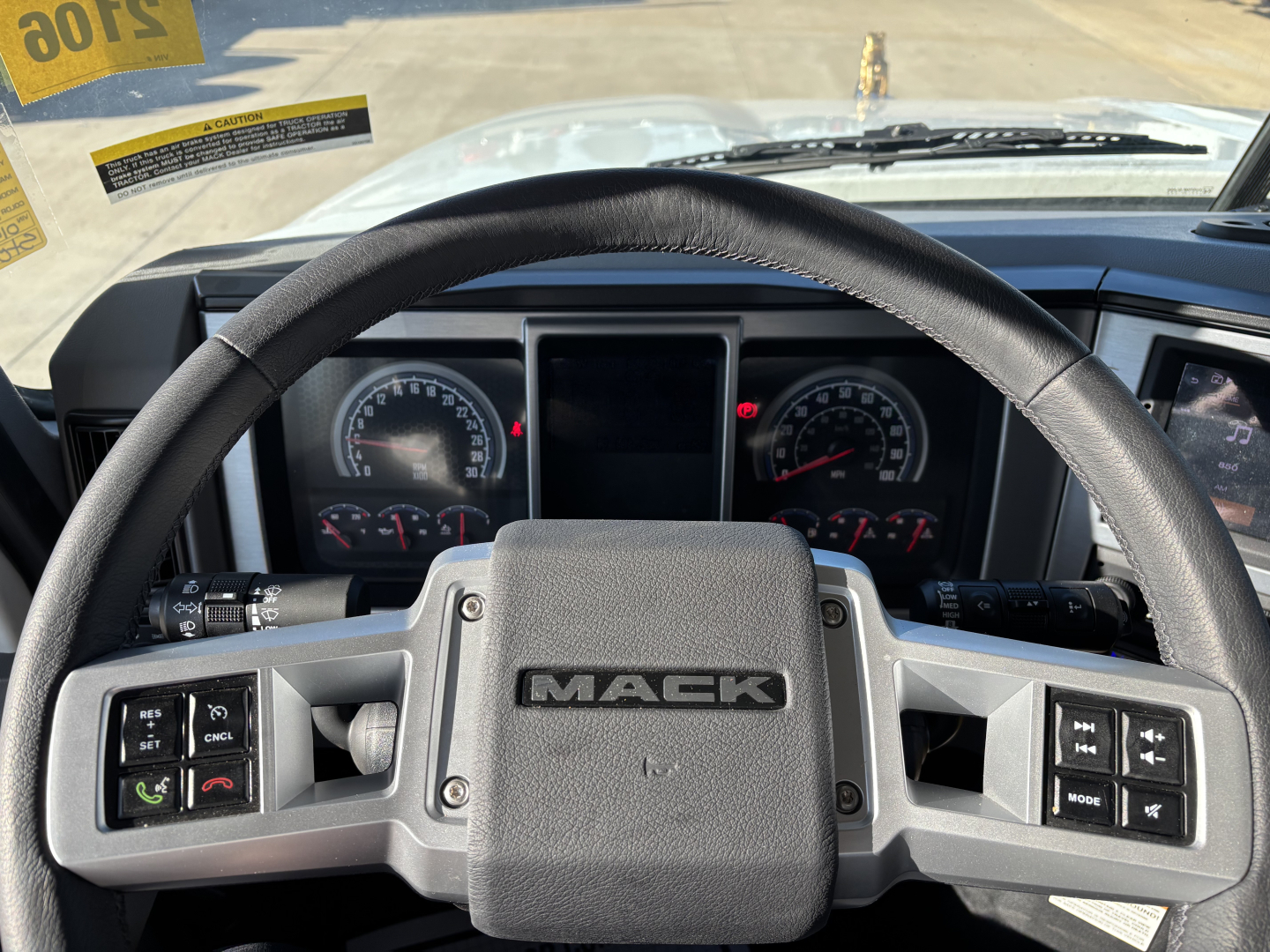 Mack PI64 truck steering wheel and dashboard view showing steering wheel with MACK logo and instrument cluster